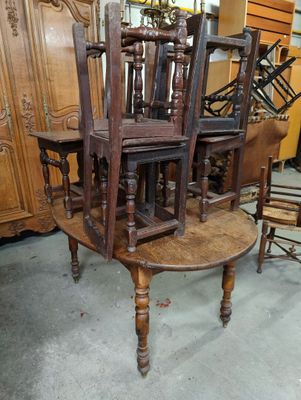 several chairs and a table are stacked on top of each other in a room