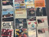a lot of music cds and cds on the table