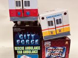 three toy ambulances sitting on top of each other