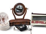 a table with a mirror, a plate, a camera, and other items