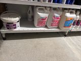 a shelf with several bottles of cleaning products on it