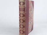 a book that is sitting on a white surface