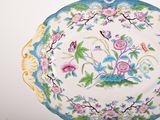 a plate with a floral design on it on a table