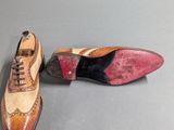 two pairs of shoes are sitting on a table next to each other