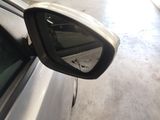 a side view mirror of a car in a garage