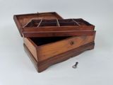 a wooden box with a key in it on a table
