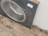 a sink in the middle of the floor in a room