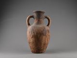 a brown vase that is sitting on a table