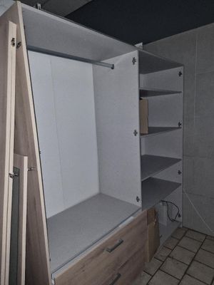 a very large closet with a built in shelf
