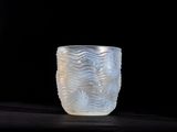 a glass cup that is sitting on a table