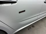 a silver car with a sticker on the side of it