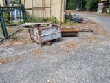 a pile of junk on the ground next to a building