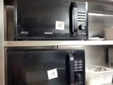 two microwaves that are on the shelves in the kitchen