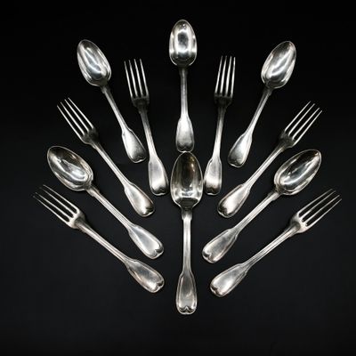 un grand nombre de cuillères et de fourchettes en argent disposées en cercle
