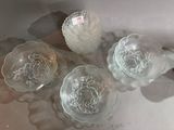 three glass bowls sitting on a table next to each other