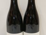 deux bouteilles de vin posées l'une à côté de l'autre sur une table