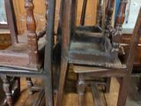 two wooden chairs sitting on top of a wooden table