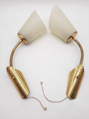 a pair of brass and white lamps on a white surface
