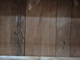 a cat that is sitting on top of a wooden shelf