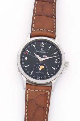 a close up of a watch on a white surface with a brown strap