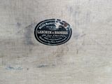a close up of a label on a piece of wood