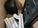 many rolls of toilet paper in a box next to a tv