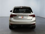 the rear end of a silver car in a white room