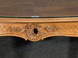 a table with a glass top and a wooden base