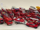 a lot of toy fire trucks that are on the table