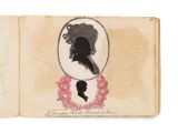 un vieux livre sur lequel figure le dessin d'une femme et d'un homme