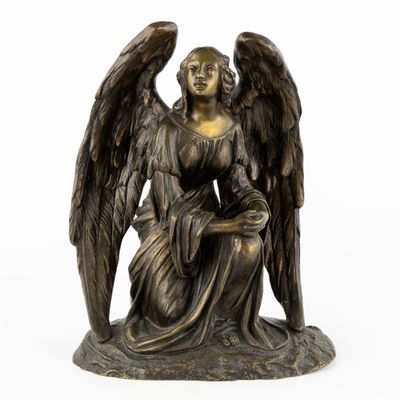 an image of a bronze statue of an angel holding a child