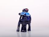 a small figurine of a man sitting on a chair