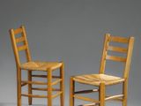 deux chaises en bois placées l'une à côté de l'autre sur une surface grise
