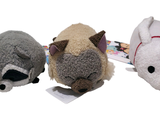 three stuffed animals sitting next to each other on a white surface