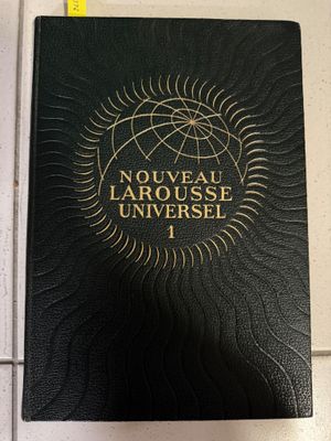 a black book sitting on top of a counter next to a ruler