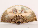 a fan with a painting on it sitting on a table