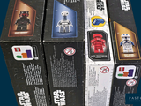 several boxes of star wars action figures are stacked on top of each other