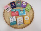 many different types of soaps on a wicker tray