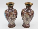 two vases sitting side by side on a white surface