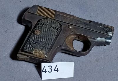 a small gun that is on a table with a price tag