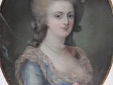 portrait of a lady in a blue dress with flowers in her hair