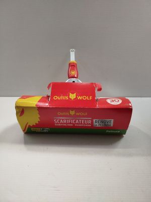a red toy boat that is on a white table