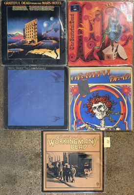 several cds and cds are sitting on the floor next to each other