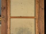 an old wooden easel with a painting on it sitting in a room