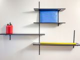 two black shelves with blue bins on them