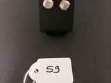 a pair of earrings on a table with a price tag