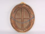 a round mirror hanging on the wall with a rope around it