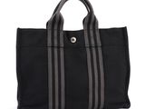 a black tote bag with grey stripes on the side