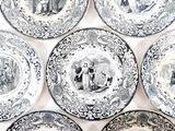 many plates with different designs on them on a table