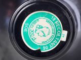 a close up of a bottle with a sticker on it